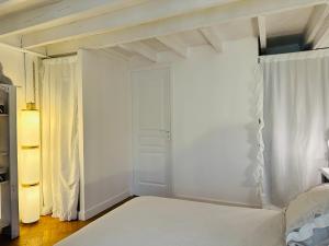 a bedroom with a white bed and a window at La Remembrance Hebergement Atypique Espace bien être Disney in Villeneuve-le-Comte