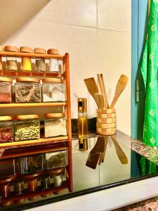 a glass counter with some spices and wooden spoons at Deluxe Flat in Muscat