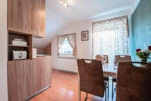 a kitchen with a table and chairs in a room at Apartment Premier in Bjelovar