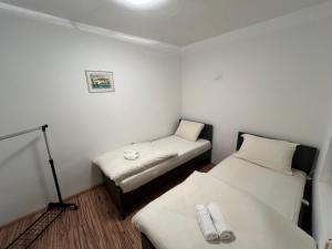 a small room with two beds in it at Gray harmony rooms in Mostar +7 photos