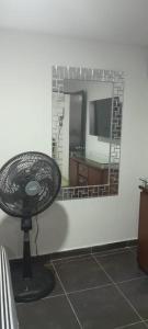 a mirror in a room with a table and a mirror at ApartaSuite El Encanto in Barranquilla