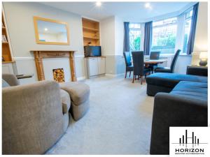 a living room with a couch and a table and chairs at Bright & Spacious Central Apartment in Harrogate