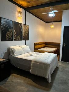 a bedroom with a large bed and a desk at Pousada Entre Folhas in Serra do Cipo +45 photos