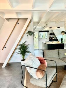 a living room with a couch and a staircase at A - (frame) - Like A dream in Durbuy
