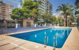 a swimming pool in a apartment with trees and buildings at Apartamentos Benicasim - La Casa Encendida in Benicàssim