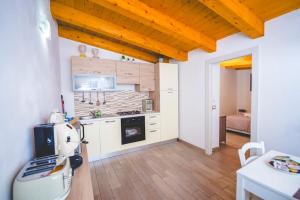 a kitchen with white cabinets and a stove at Casa Martina in Siracusa