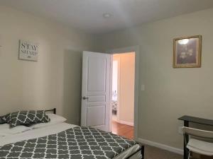 a bedroom with a bed and an open door at Charming Urban Apartment Getaway in Providence