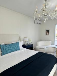 a bedroom with a large bed and a chandelier at Misk Villa - Boutique Hotel & Spa in Sidi Bou Saïd