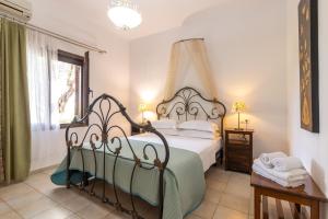 a bedroom with a bed with a wrought iron headboard at Angela Studios in Syvota