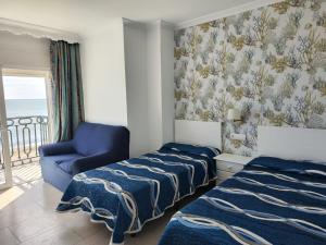 Posteľ alebo postele v izbe v ubytovaní Apartamentos Caracas