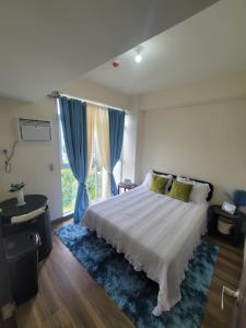 a bedroom with a bed and a large window at Newcoast Boracay Top Floor View in Boracay +17 photos