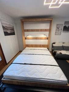 a bedroom with a large bed in a room at Cosy studio for 4 near ski lift, CRETES B24 in Les Collons