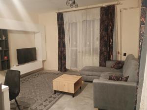 a living room with a couch and a tv at Urocza 20 KRAKÓW in Krakow