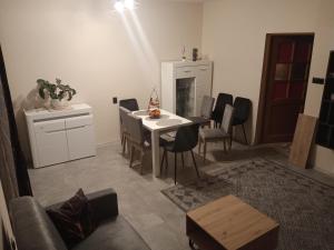 a living room with a white table and chairs at Urocza 20 KRAKÓW in Krakow