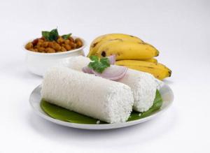 a plate of food with a bunch of bananas at Mountain View Villa in Mukkam