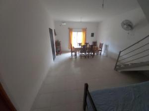 a room with a dining room and a table and chairs at Casa en los Valles in Cafayate +3 photos