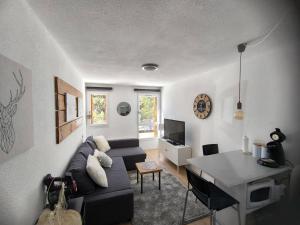 ein Wohnzimmer mit einem Sofa und einem Tisch in der Unterkunft STUDIO COSY ISARD P2000 in Bolquere