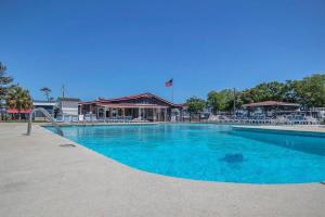 a large pool with blue water in a resort at Surf City 2BR Model Home with Pool and Boat Ramp Access in Surf City
