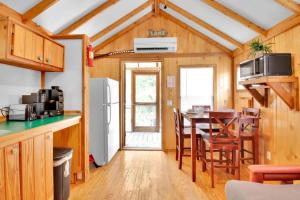 a kitchen and dining room with a table and chairs at Charming Log Cabin in Bloomington in Bloomington