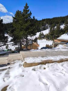 a snow covered parking lot with a ski slope at STUDIO COSY ISARD P2000 in Bolquere Pyrenees 2000