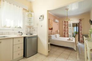 a kitchen and bathroom with a tub and a sink at Angela Studios in Syvota