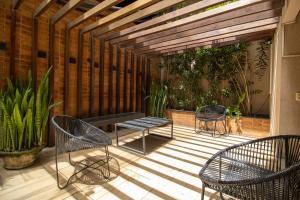 a patio with two chairs and a bench on it at Anna Suites Arpoador in Rio de Janeiro