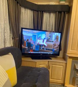 a flat screen tv sitting in a living room at Static van on Smallgrove in Ingoldmells in Skegness