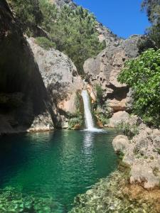 a waterfall in the middle of a pool of water at casa CAZORLA C DEL VALLE in Cazorla