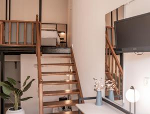 a room with a loft bed and a tv at Casa Veneta in Chania Town
