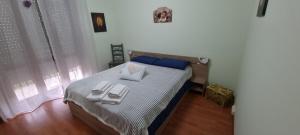 a bedroom with a bed with two napkins on it at A PLACE TO REMEMBER in Montegrosso dʼAsti