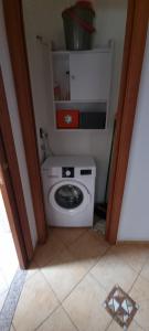 a bathroom with a washing machine in a room at A PLACE TO REMEMBER in Montegrosso dʼAsti