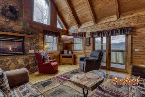 a living room with a fireplace in a log cabin at Top of the World 2 Bedroom 2 Bath Cabin between Pigeon Forge and Gatlinburg in Pigeon Forge