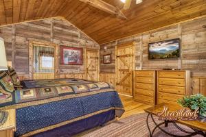 a bedroom with a bed in a room with wooden walls at Top of the World 2 Bedroom 2 Bath Cabin between Pigeon Forge and Gatlinburg in Pigeon Forge
