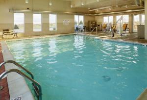 a large swimming pool with blue water at Hyatt Place Grand Rapids South in Wyoming
