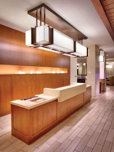 a lobby with a reception desk and a chandelier at Hyatt Place Waikiki Beach in Honolulu