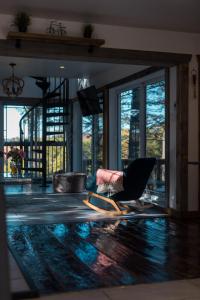 a living room with a chair and a pool at LoveNestChalet - Hot tub & Fireplace - Warm, cozy & relaxing in Grenville-sur-la-Rouge