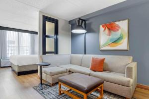 a living room with a couch and a chair at Hyatt Place Houston-North in Houston