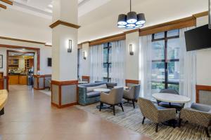 a lobby with a waiting area with chairs and tables at Hyatt Place Houston-North in Houston