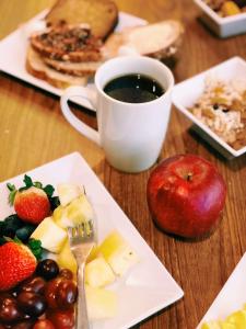 a table with a plate of fruit and a cup of coffee at Hyatt Place Chantilly Dulles Airport South in Chantilly