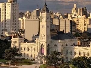 a large white building with a clock tower in a city at Moreno home in La Plata
