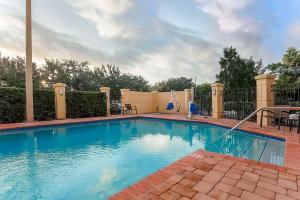 a swimming pool with blue water in a yard at Hyatt Place Lake Mary/Orlando North in Lake Mary