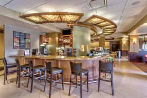 a bar in a restaurant with chairs around it at Hyatt Place Kansas City/Overland Park/Convention Center in Overland Park