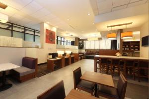 a restaurant with tables and chairs and a bar at Hyatt Place Flushing/LGA Airport in Queens +38 photos
