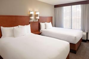 A bed or beds in a room at Hyatt Place Ontario/Rancho Cucamonga