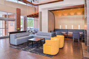 a lobby with couches and tables and chairs at Hyatt Place Chesapeake in Chesapeake
