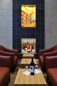 a restaurant with two tables and a painting on the wall at Hyatt Place Chesapeake in Chesapeake
