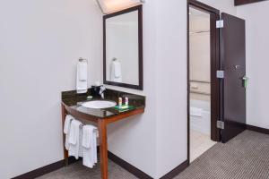 a bathroom with a sink and a mirror at Hyatt Place Chesapeake in Chesapeake