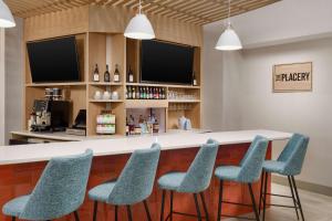 a bar with blue chairs and a counter at Hyatt Place across from Universal Orlando Resort in Orlando