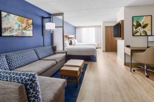 a hotel room with a couch and a bed at Hyatt Place across from Universal Orlando Resort in Orlando +62 photos