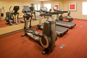a gym with several treadmills and elliptical machines at Hyatt Place Santa Fe in Santa Fe